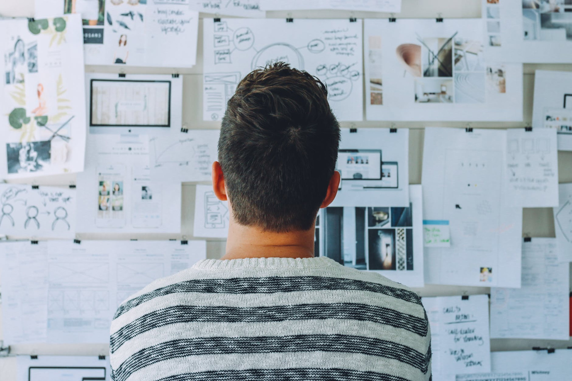 Man looking at papers used for experimenting on new web designs