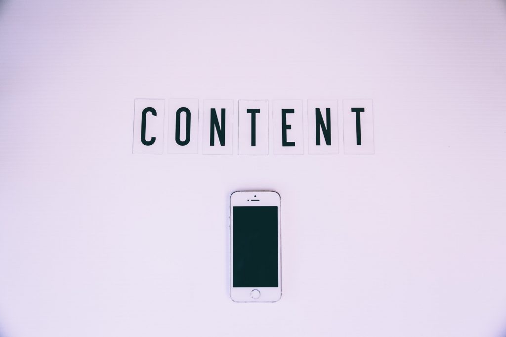 Content written above an iPhone.