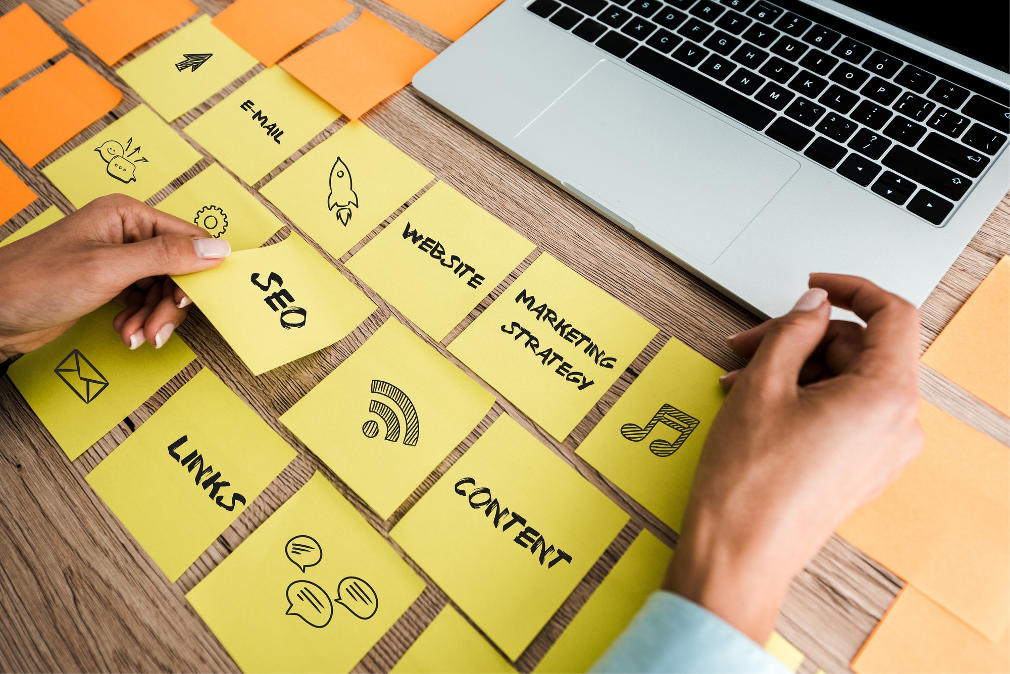 The Future Of SEO . Sticky note with SEO lettering near laptop on desk.