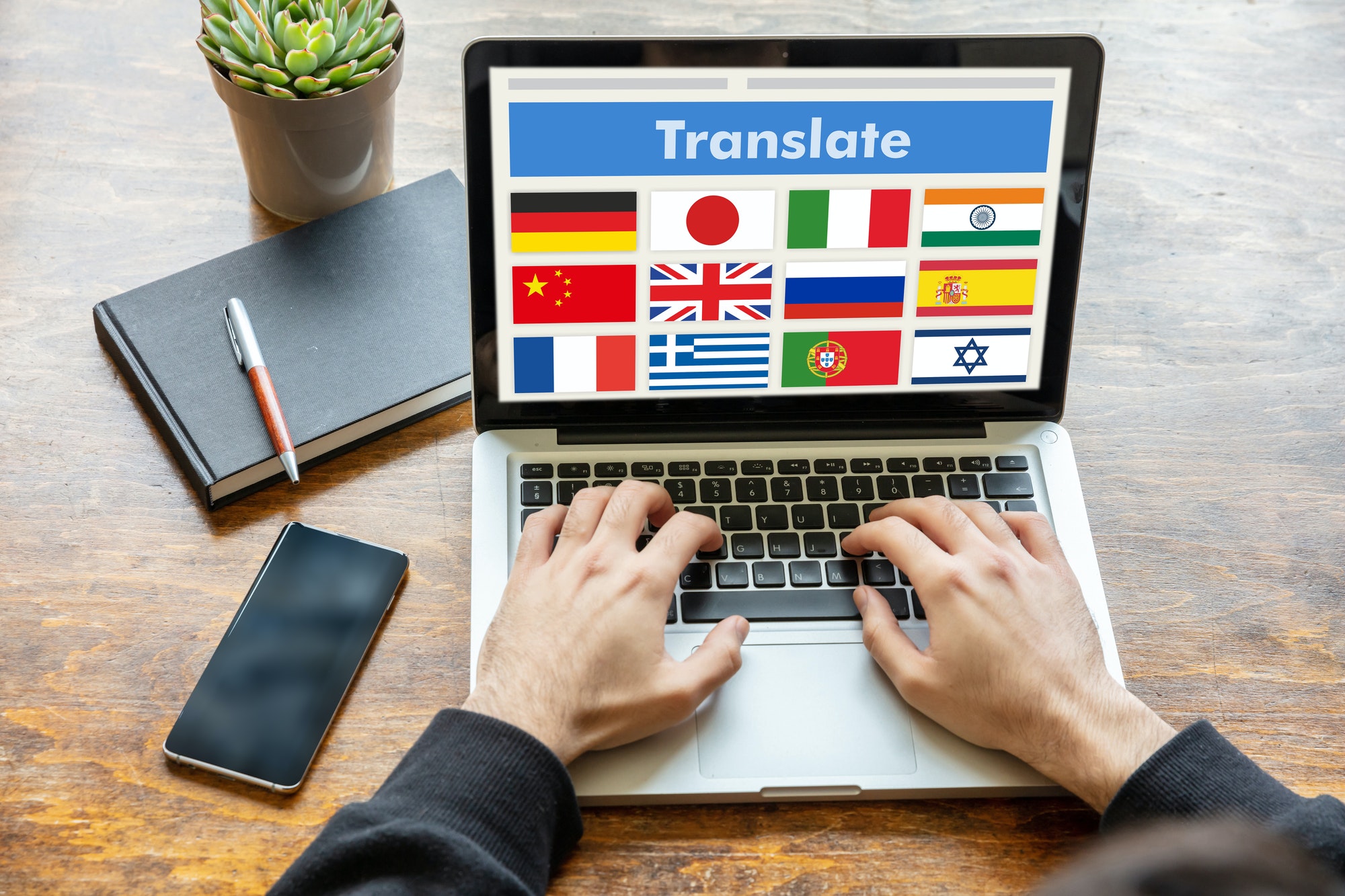 Man working on a laptop with the word translate on the computer screen.