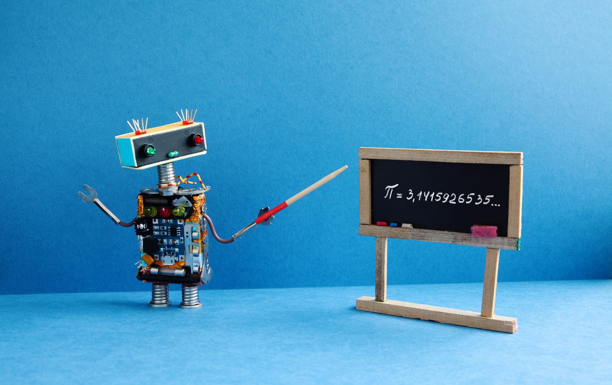 Mathematics is key. Robot showing math on blackboard. 