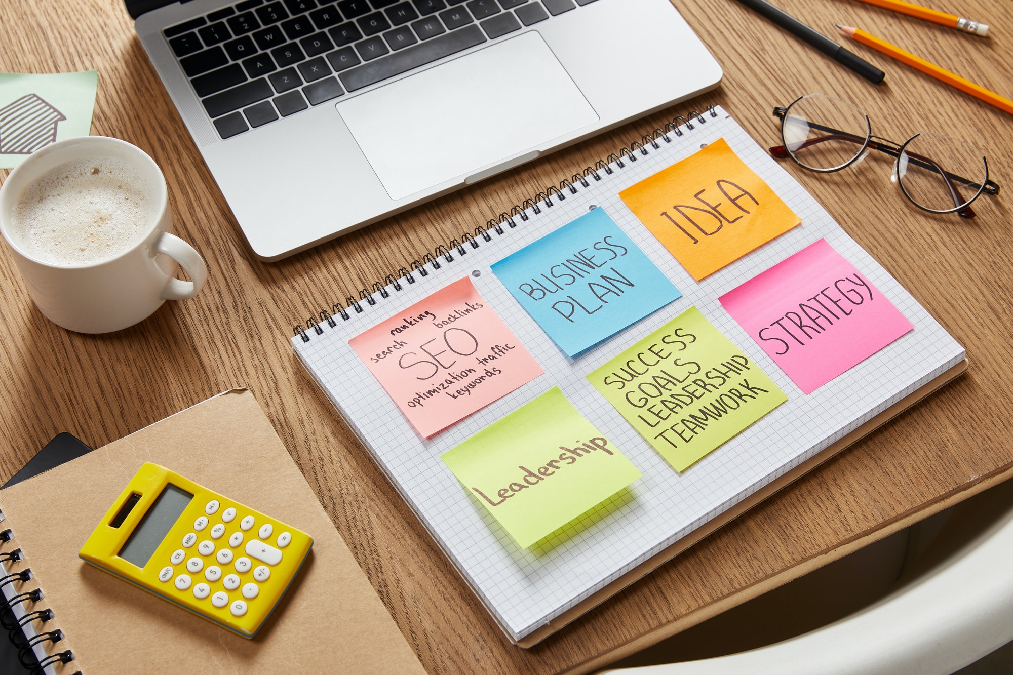 Paper stickers with business strategy and SEO stickers.