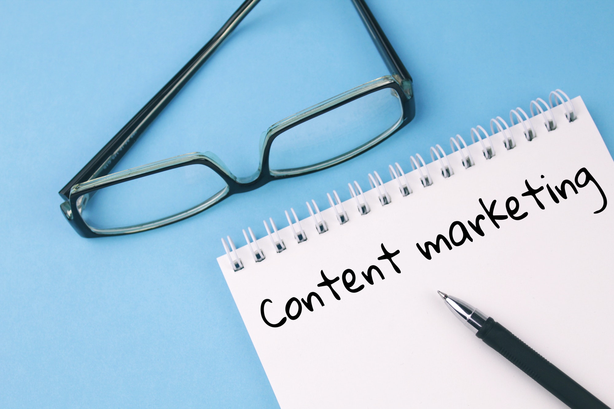 Embrace Content Marketing | St. Louis Marketing Agency Reading glasses and blank with word content marketing/