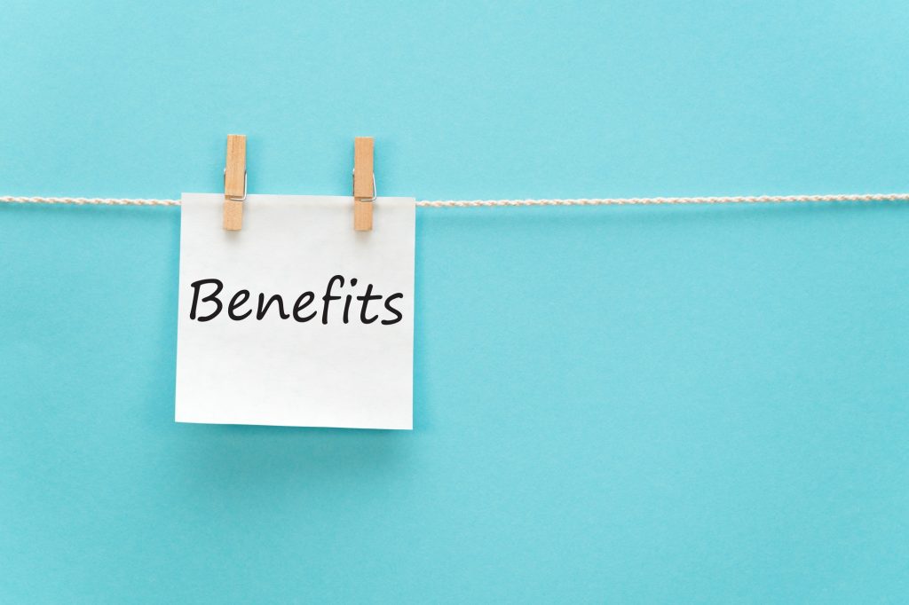 Employee benefits. Benefits written on a note and hanging.