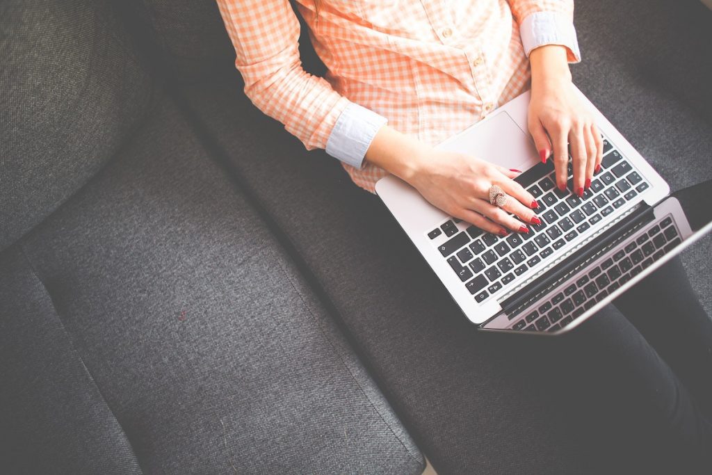 Woman on her laptop learning how to build a website that propels your business, 