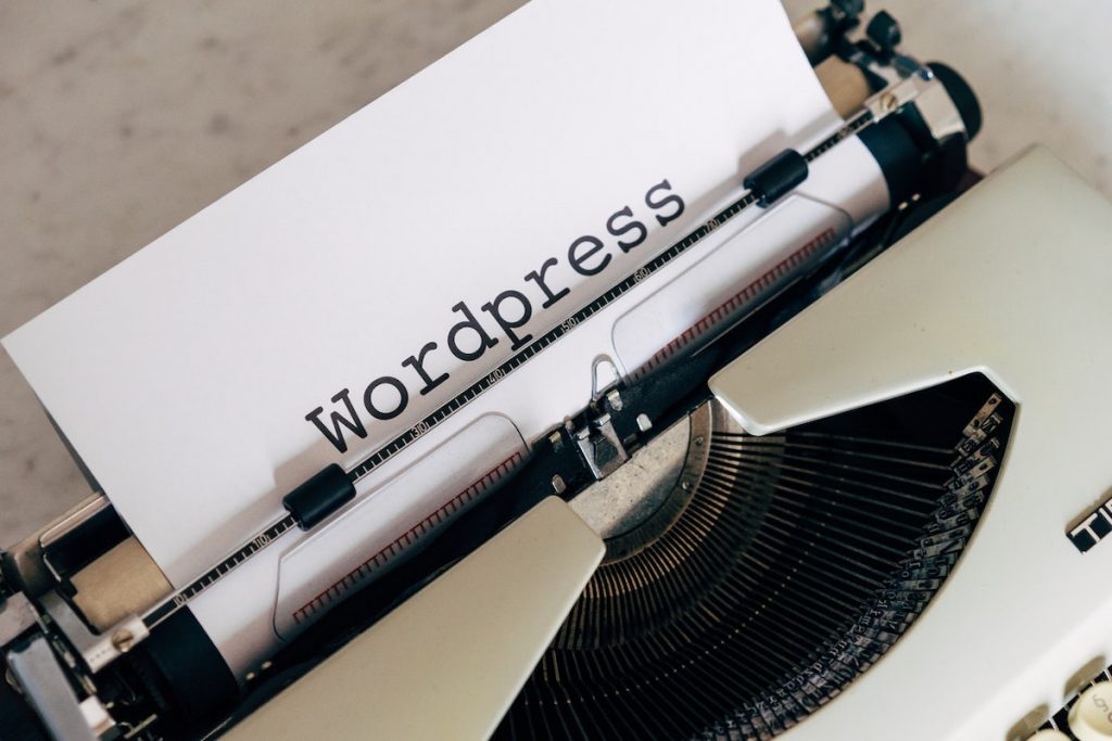 Typewriter with WordPress words typed on it.