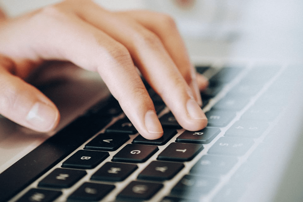 Person using a laptop while they organize remote work.