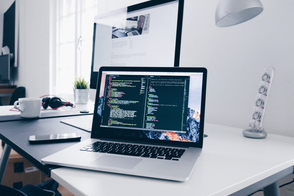 a laptop with with website development work on the screen.