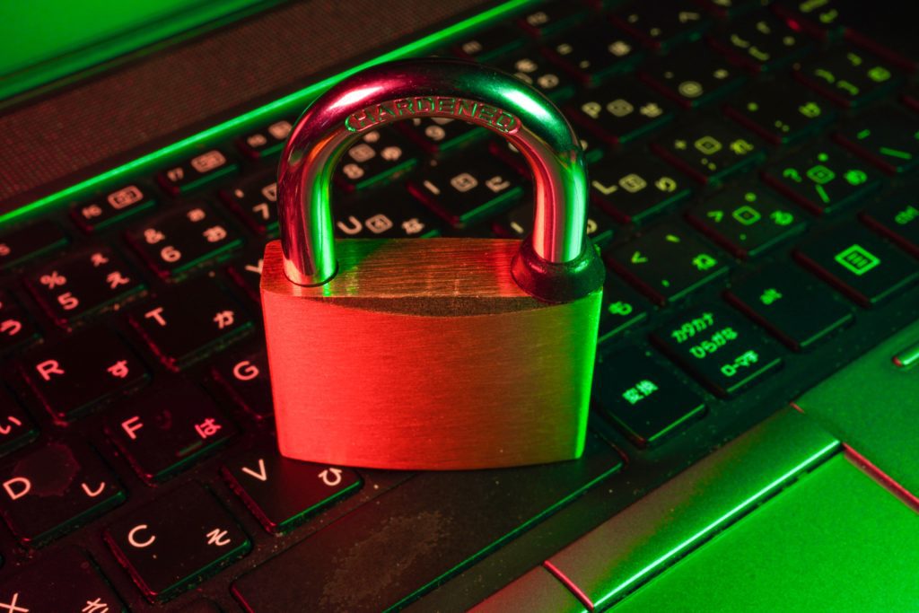 A laptop keyboard with a padlock on top of it.