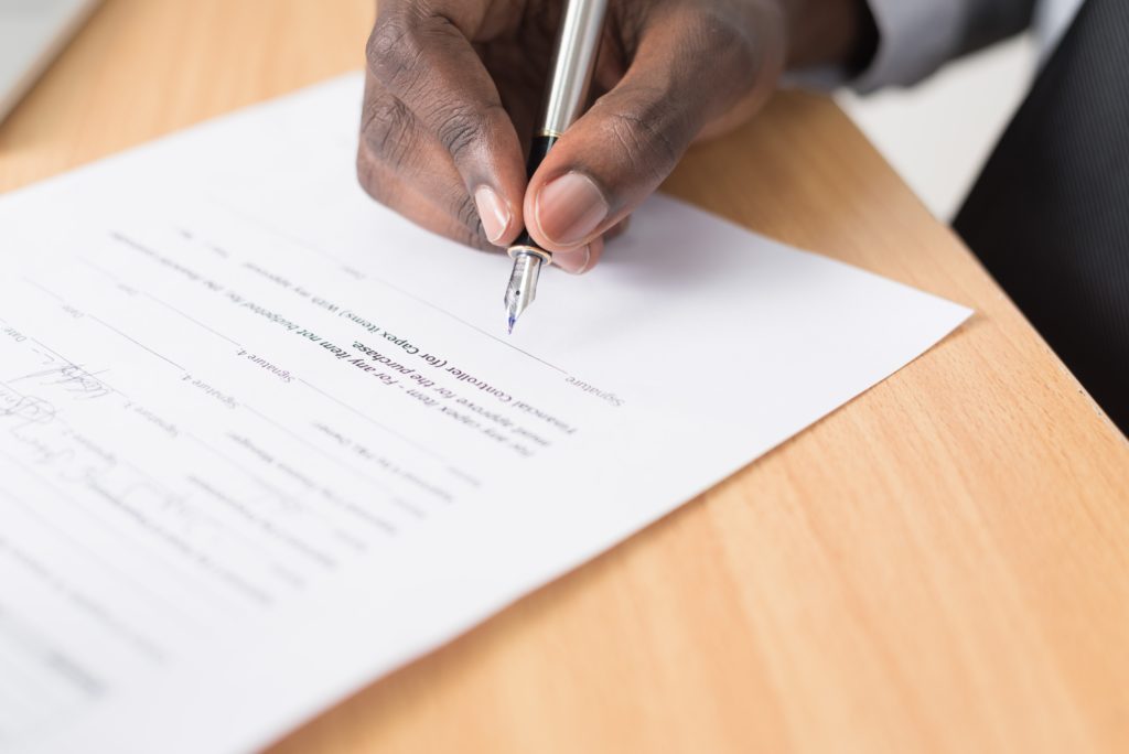 A man writing a legal contract for a website