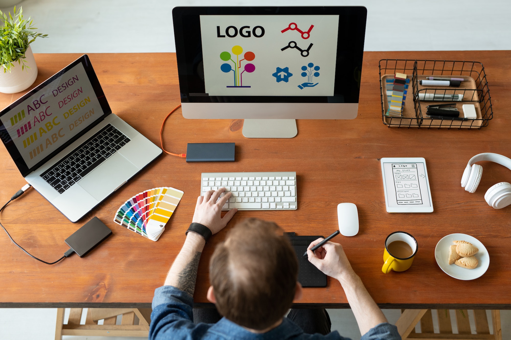 Logo designer at work. 7 Tips To Elevate Your Website's Visual Identity Using Easy Logos.