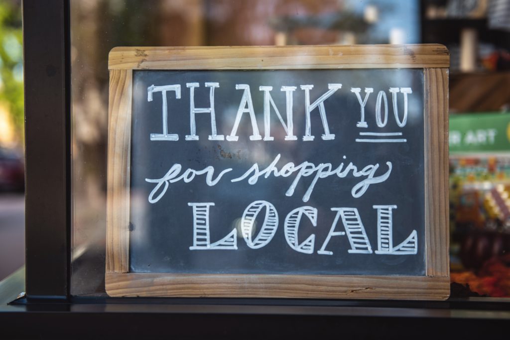 A sign that says "thank you for shopping local"