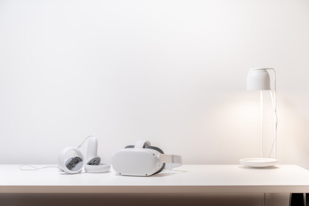 A white VR headset on a white desk.