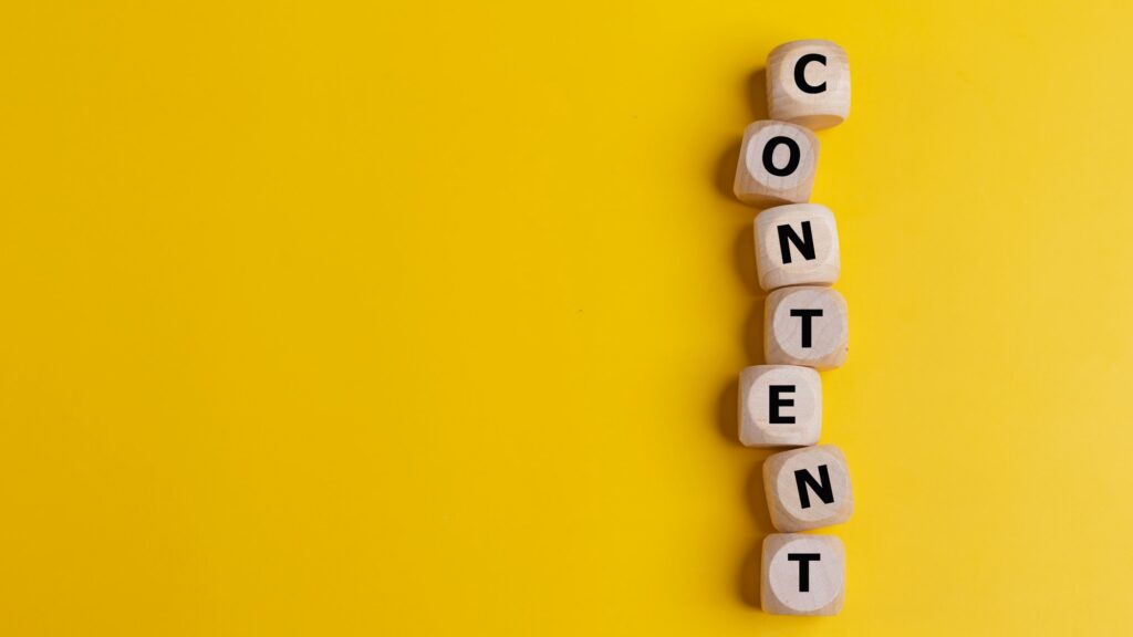 Cubes with the word CONTENT on a yellow background.Content creation. Decide On Content Types.