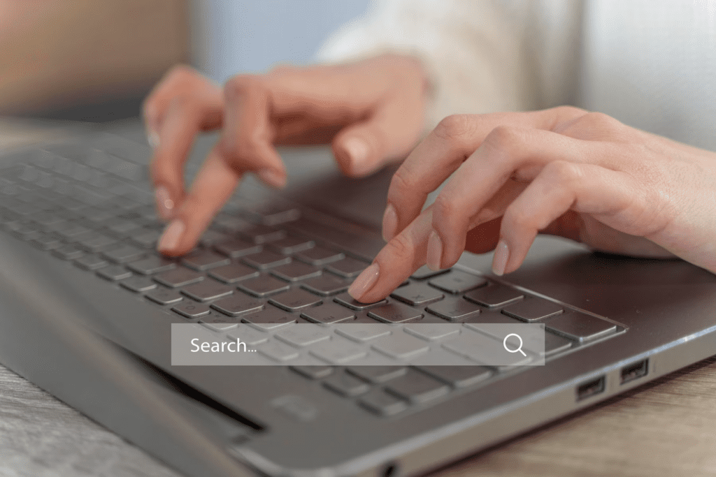 Person using a keyboard for social media insights.