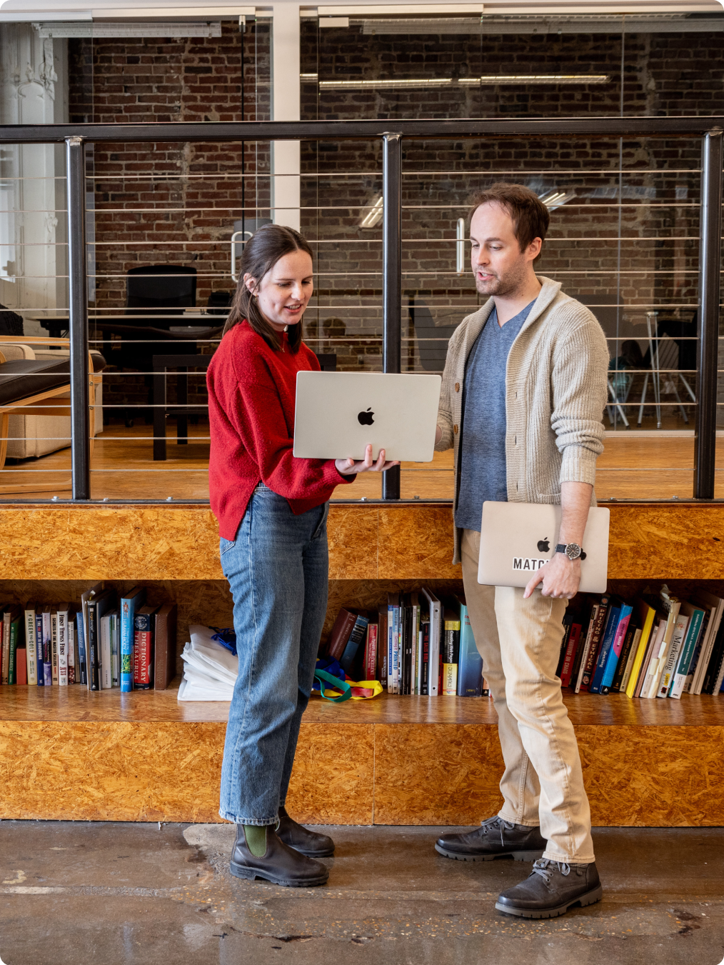 Two employees talking over a laptop