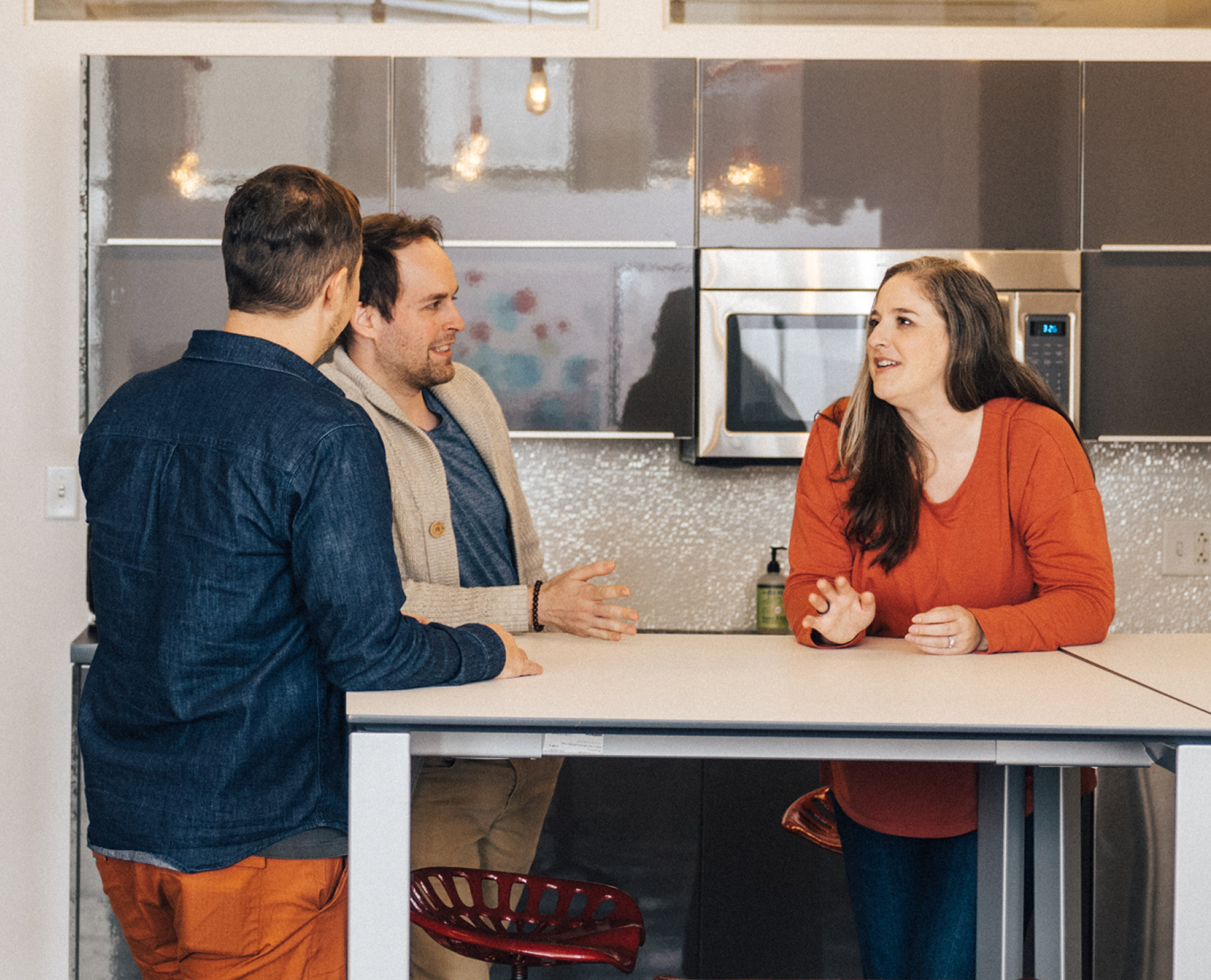 coworkers chatting in office kitchen